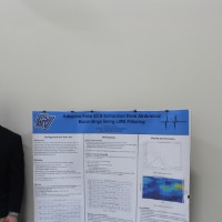 A student standing next to an ECG extraction project.